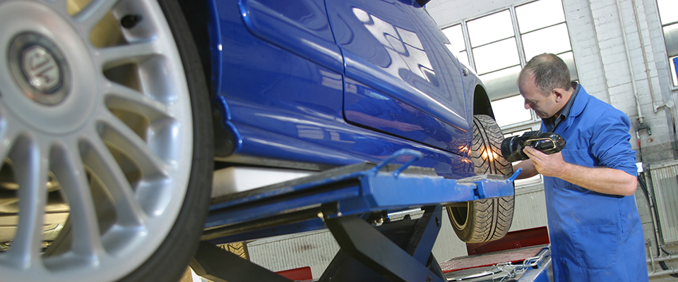 Mechanic at work on car engine