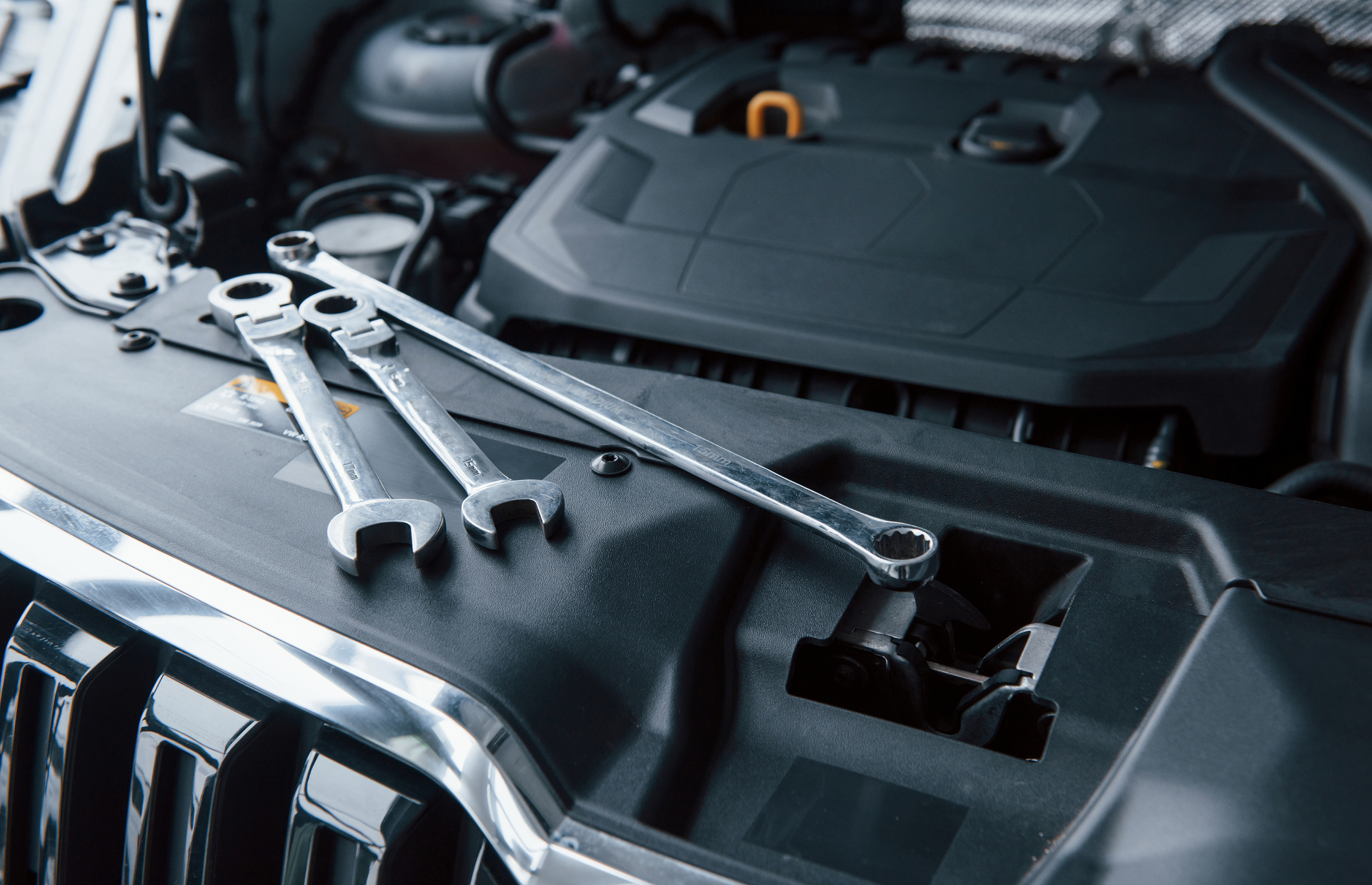 Mechanic at work on car engine