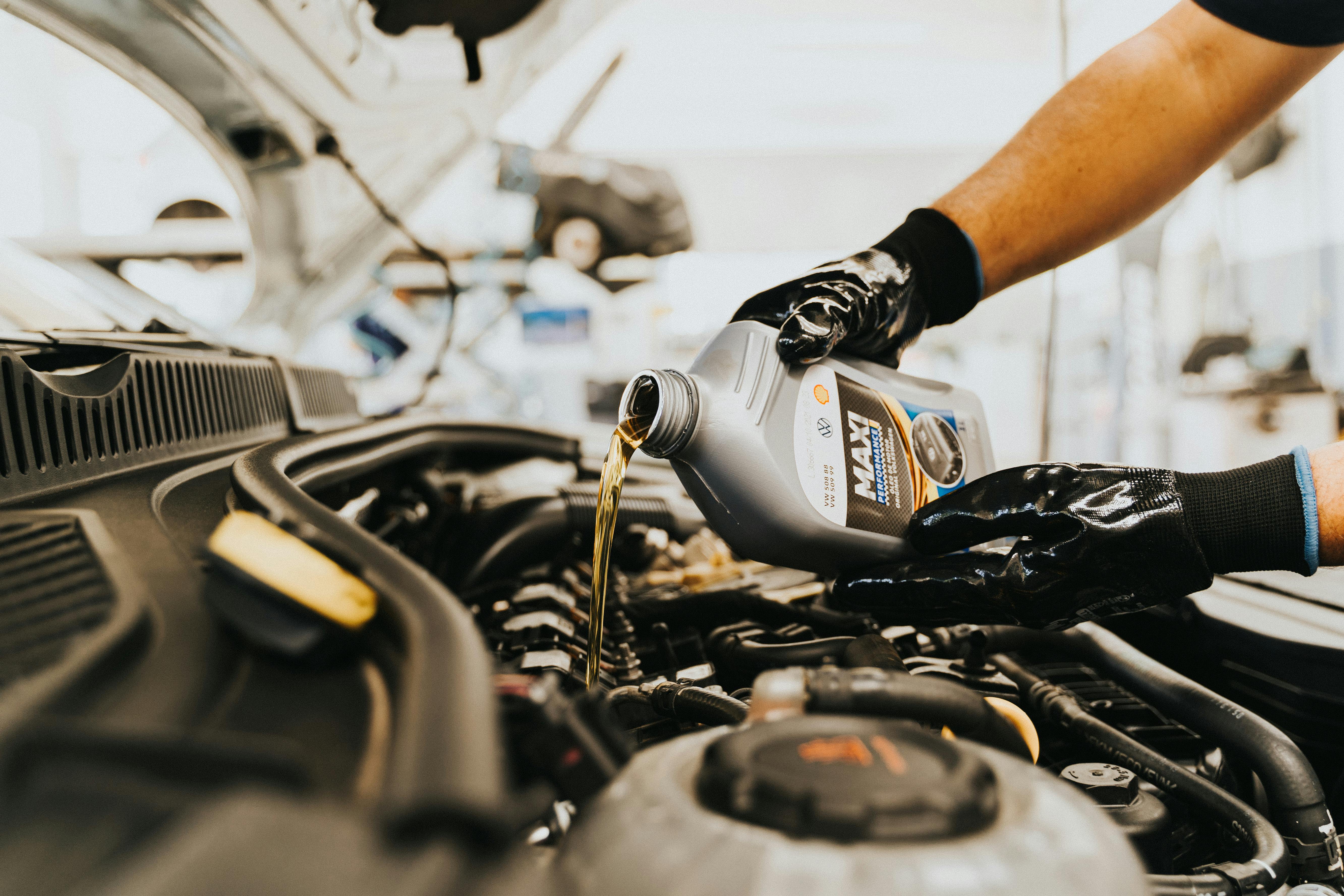 Mechanic at work on car engine